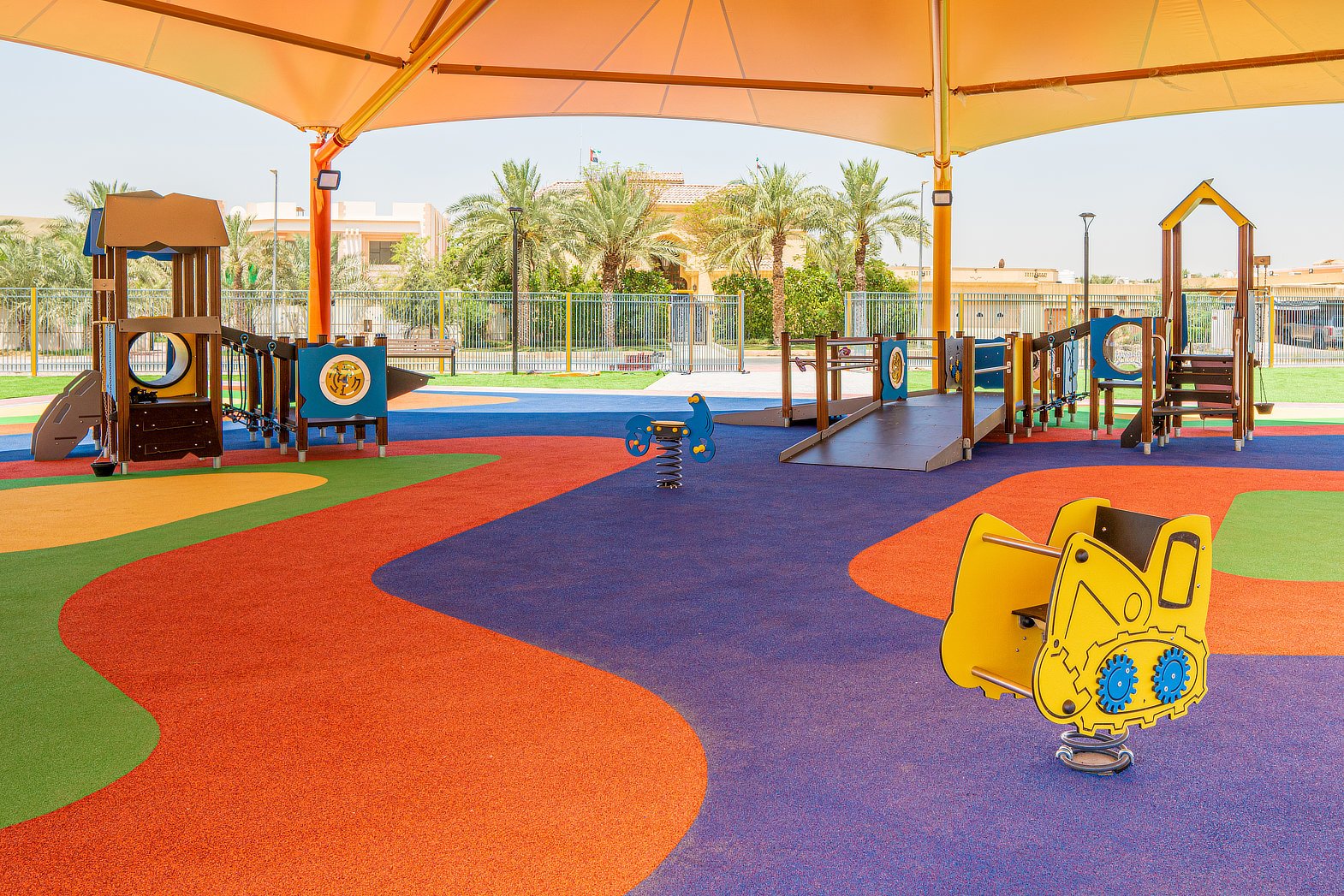 Colourful school playground with safety surfacing and play equipment installed by Commercial Play